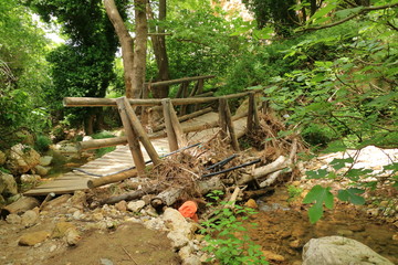 Closeup of deformed and dilapidated wooden bridge on Crete, Greece