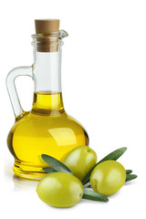 Delicious olive oil in a glass bottle and green olives with leaves, isolated on white background