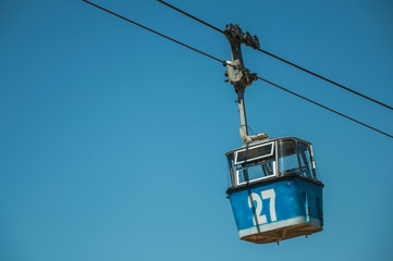 Cable car gondola passing through clear blue sky in Madrid