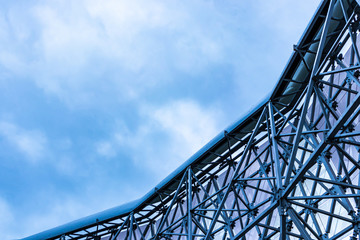 The metal frame of building in the style of minimalism or high-tech. Glass elements of rhombus in...