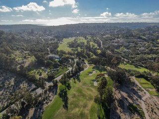 Aerial view of a beautiful wealthy green golf course next the valley. San Diego, California. USA. 