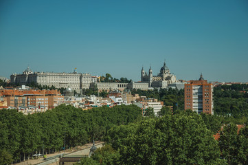 Fototapeta na wymiar Royal Palace and Almudena Cathedral with trees from garden at Madrid