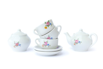 Vintage toy tea-set on white background