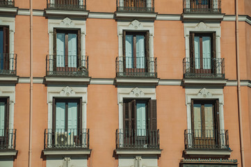 Fototapeta na wymiar Building with colorful facade and glazed windows in Madrid