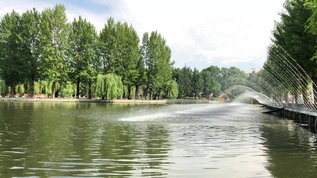 Fountain on the lake in the park. The fountain is located along the lake embankment in Ternopil, Ukraine.