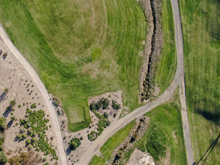 Fototapeta premium Aerial top view of a green golf course during sunny day. South California.