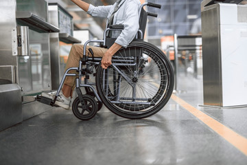 Mature lady on disabled carriage moving check-in counter