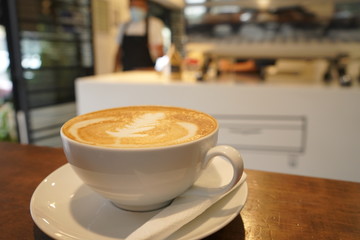 Cup of coffee on the table in coffee shop, with coffe