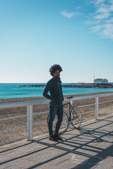 Man with afro hair riding a vintage style bicycle