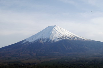 Naklejka na ściany i meble Close up top of beautiful Fuji mountain with snow cover on the top with could, Japan 