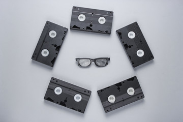 Retro style Minimalism. Video tapes, 3D glasses on a gray background. Top view.
