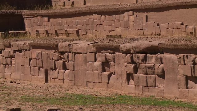 Close-up high angle panning shot of ancient walls and stone blocks at Tiwanaku Ruins, La Paz, Bolivia