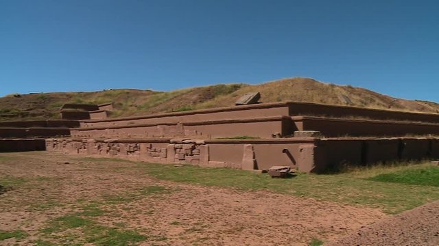 Medium low-angle panning shot of reconstructed Tiwanaku Ruins, La Paz, Bolivia