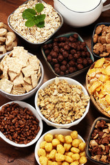Cereal. Bowls of various cereals and milk for breakfast. Muesli with kids cereals.