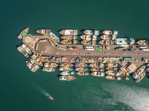 Aerial view of wooden boats in Dubai Dhow Wharfage harbour, UAE.