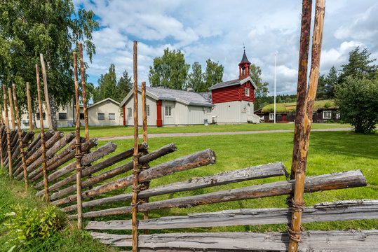 Typical Norwegian buildings of town Koppang with wooden palisade at foreground.