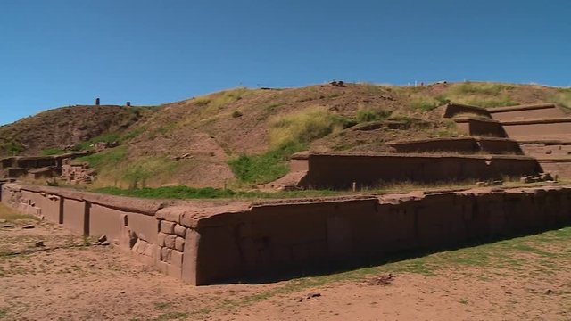 Medium low-angle corner-view panning shot of Akapana pyramid wall ruins, La Paz, Bolivia