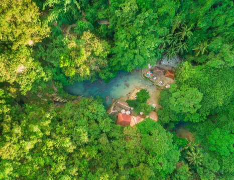 Aerial view of people swimming in pool by Kawasan Falls in Alegria, Philippines.
