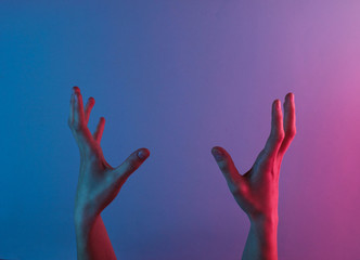 Awesome female hands with blue neon red light. Halloween theme. Minimalism fashion. Surrealism. Concept art