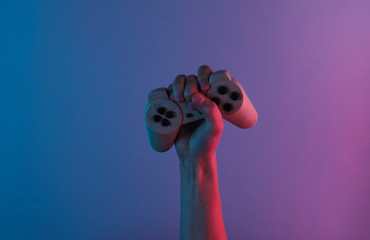Hand holds a gamepad with red blue neon light. Minimalism, concept art
