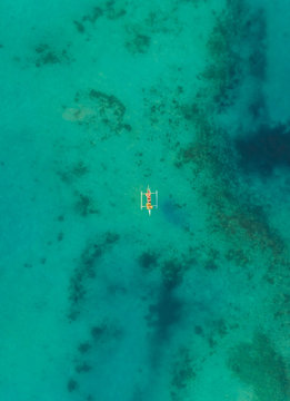 Aerial view of one boat in turquoise waters near Tagbilaran city, Philippines.