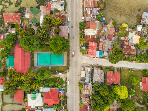 Aerial view of residential district with tennis court in Dauis, Philippines.