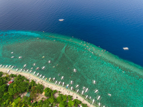 Aerial view of beach, buildings, filipino boats, Balicasag Island, Philippines.