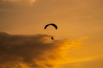 The silhouette of the paramotor at sunset