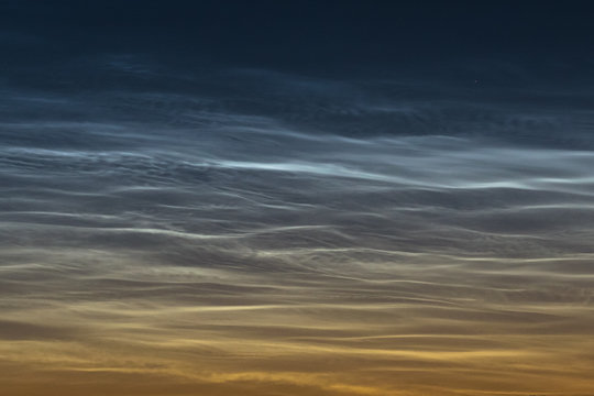 Detailed view of noctilucent clouds (NLC, shining night clouds) with beautiful curls and whirls