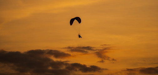 The silhouette of the paramotor at sunset