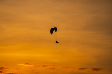 The silhouette of the paramotor at sunset