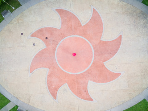 Aerial view of person holding colorful umbrella on pebble background, USA.
