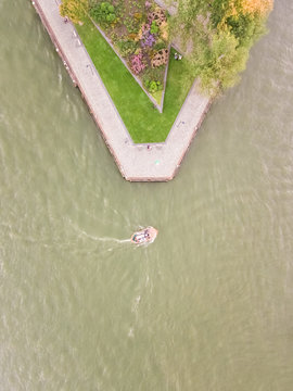 Aerial view of a boat driving on Nieuwe Maas river in Rotterdam, The Netherlands.