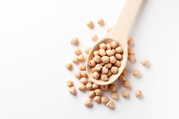 Chickpea in a wooden spoon isolated on white background