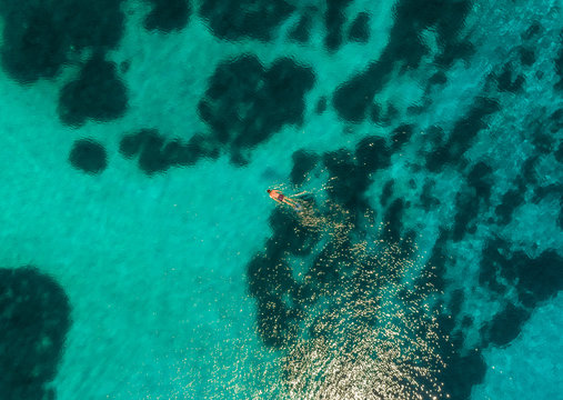 Aerial view of woman swimming with flippers in the sea of Maganisi island, Greece