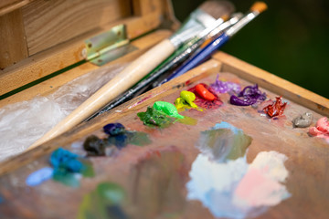 Artist's tablet with paints and brushes