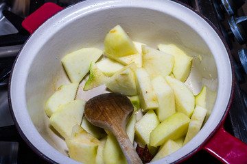 Apple in pan about to be cooked with apple sauce.
