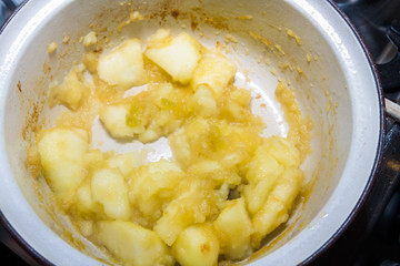 Apple in pan being cooked to make apple sauce nearly finished.