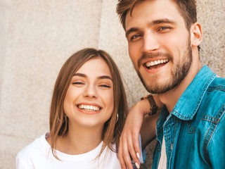 Smiling beautiful girl and her handsome boyfriend in casual summer clothes. Happy family taking...