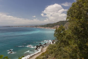 Fotobehang Giardini Naxos Sicily panorama of the coast and bay, beautiful sea with some rocks, trees and green hills © AlessioDCAuditore