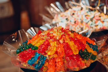 Multicolored marmalade lies on the shelves of the store