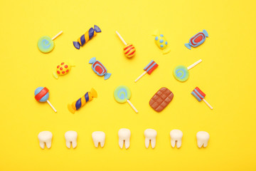 Teeth with sweet candies. Tooth caries in children's, dental healthcare.