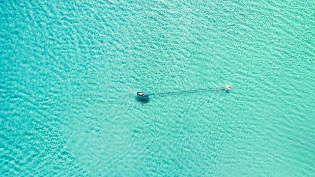 Aerial photography of people swimming in the clear blue sea of the greek island Andros.