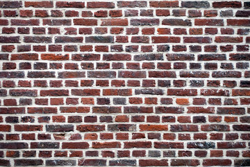 Multicolor wall of red and brown bricks. Texture background