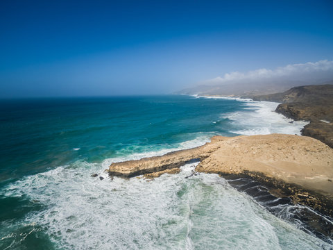 Aerial view of waves crashing of the rocks of punta Guadalupe in Fuerteventura, Canary Island.