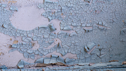 Old cracked blue faded on a white painted wall