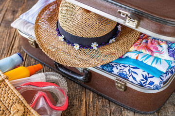 Suitcase preparation for a summer holiday , Retro , vintage and old luggage ( suitcase concept )  