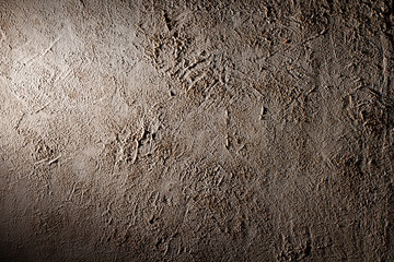 Rough plaster wall yellow with obvious divorces on the surface, texture