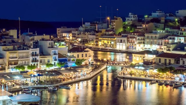 The lake Voulismeni and Agios Nikolaos town at night on the island Crete, Greece