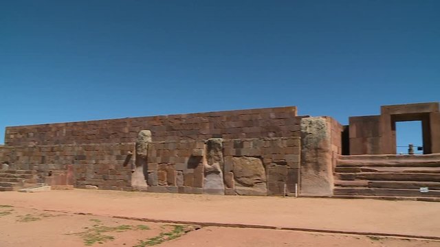 Medium close-up low angle panning shot of the external walls and gate of the ancient Kalassaya, Tiwanaku, Bolivia.
